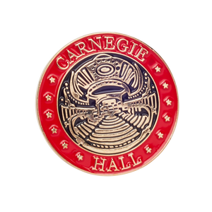 Circular red, gold, and black lapel pin with gold stars on the edge and Stern Auditorium/Perelman Stage in the middle.