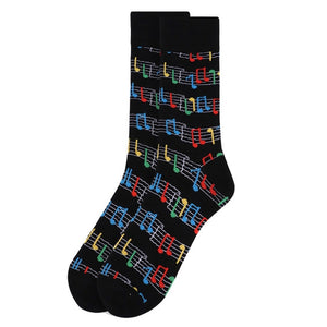 A pair of black socks with red, green, blue and yellow musical notes. 