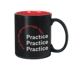 A black mug with red interior, featuring the words "How do you get to Carnegie Hall?" in an arc over the words "Practice Practice Practice" in white lettering. 