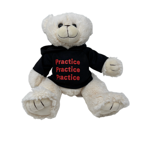 A white plush teddy bear wearing a black hooded sweatshirt. 