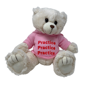 A white plush teddy bear wearing a pink hooded sweatshirt. 